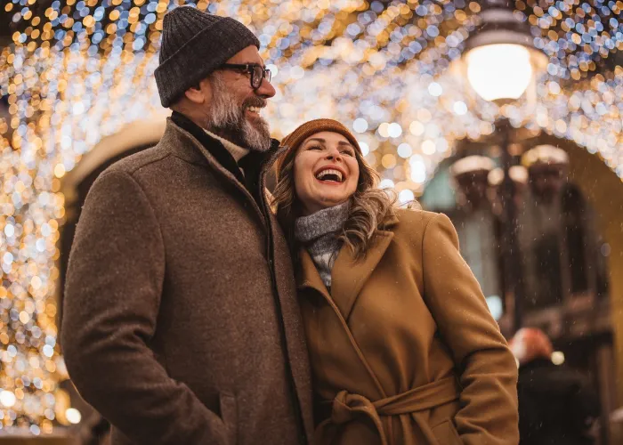 Mature couple in the city walking and having fun on winter day.